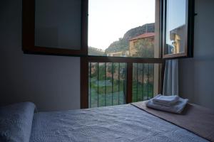 a bedroom with a bed and a large window at El Vino y sus Musas Clavijo in Clavijo