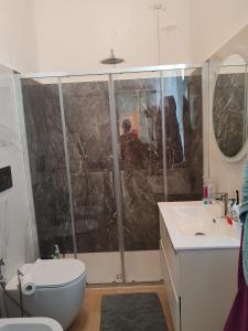 a bathroom with a shower and a toilet and a sink at Tramonti sul mare in Marina di Pisa