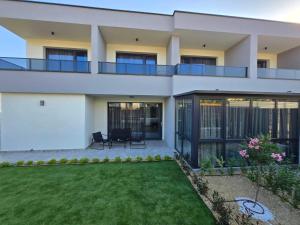 a house with a lawn in front of it at Villa Cadaques, private pool with heating and salt water in Lozenets