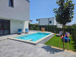a swimming pool in the backyard of a house at Villa Cadaques in Lozenets