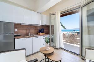 a kitchen with a table and a view of the ocean at Sea Spot Apts in Sitia