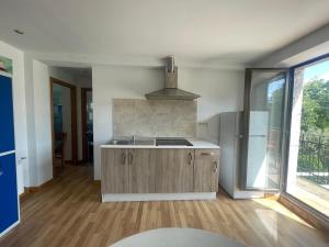 a kitchen with a sink and a stove at Albergue de Espinosa in Espinosa del Camino
