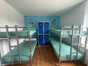 two bunk beds in a room with a ceiling at Albergue de Espinosa in Espinosa del Camino