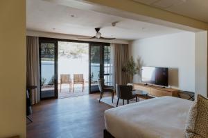 a hotel room with a bed and a desk and a television at Laborie Estate in Paarl