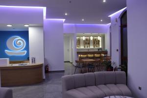 a lobby with a table and chairs and purple lighting at Oceanis Hotel in Karpathos