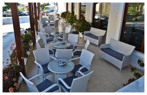 a row of tables and chairs on a patio at Oceanis Hotel in Karpathos