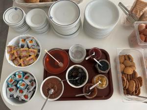 a table with plates and bowls of food on it at Oceanis Hotel in Karpathos