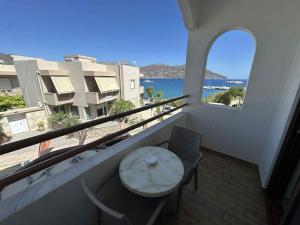 a balcony with a table and a view of the ocean at Oceanis Hotel in Karpathos