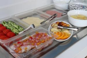 a plastic container filled with different types of fruits and vegetables at Oceanis Hotel in Karpathos