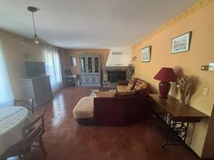 a living room with a couch and a table at Villa VERDOLINE in Digne-les-Bains