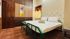 a bedroom with a large bed in a room at Divine Homestay by EDAC in Chidambaram