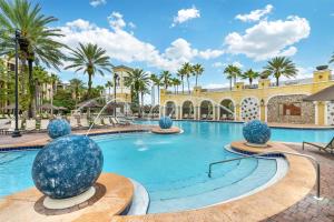 a swimming pool at a resort with palm trees at Hilton Grand Vacations Club Tuscany Village Orlando in Orlando