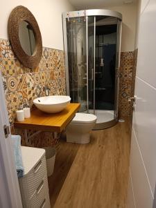 a bathroom with a toilet and a sink and a shower at Noelmar II Combarro in Combarro