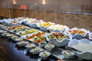 a buffet line with many different dishes of food at Ecotel Dahab Bay View Resort in Dahab