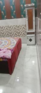 a room with a bed and a stove in it at Little KANHA ji PG 10 Room82798s58346 Hotal, also taxi and Activa rent in Mathura