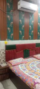 a bed in a room with avertisement at Little KANHA ji PG 10 Room82798s58346 Hotal, also taxi and Activa rent in Mathura +12 photos