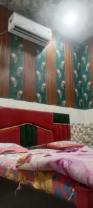 a room with a bed with a projector on the wall at Little KANHA ji PG 10 Room82798s58346 Hotal, also taxi and Activa rent in Mathura