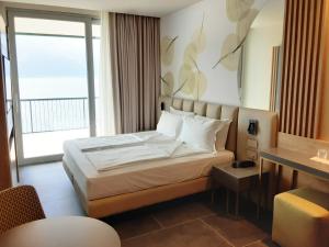 Postel nebo postele na pokoji v ubytování HOTEL ASTOR
