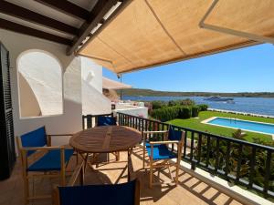 a view from the balcony of a house with a table and chairs at Es Castell 1 7 by SOM Menorca in Fornells