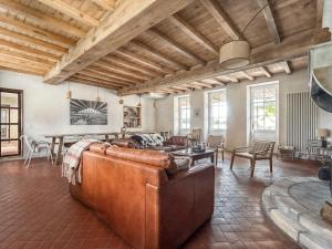 a living room with a couch and a table at La Ferme du Domaine de Bassol - Piscine & Billard in Mézériat