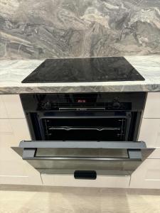 a stove in a kitchen with a counter top at Aerodromas K3 in Palanga