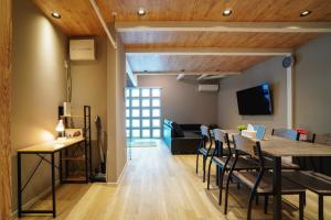 a dining room and living room with a table and chairs at Kotobuki in Otaru