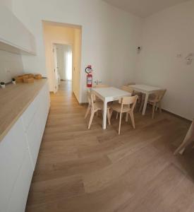 een eetkamer met een witte tafel en stoelen bij Ampia Camera Luxury in Centro RC - BagnoFrigoBar in Reggio di Calabria