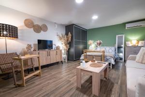 a living room with a couch and a table at Boho Nest in Glyfada by ΜΡS in Athens