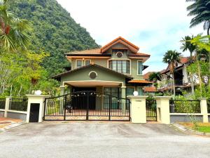 a house with a gate in front of it at Sunway Lakeside Bungalow in Ipoh in Ipoh
