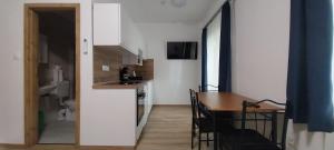 a kitchen and dining room with a table and a kitchen and a room with at Boglár-Coop Üdülő in Balatonboglár