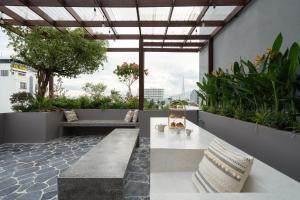 a patio with a white table and some plants at Wazen Retreat Villa Danang in Da Nang