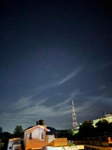 a view of the eiffel tower at night at JMS Holiday homes in Coonoor +4 photos