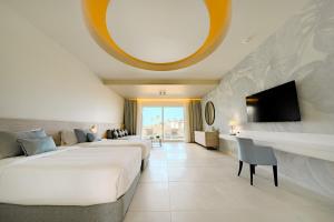 a hotel room with two beds and a tv at Sentido Reef Oasis Suakin Resort in Marsa Alam City