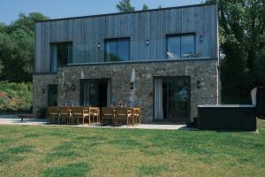 a building with a group of chairs in front of it at Brockview House - Eco 4 bed in Holcombe