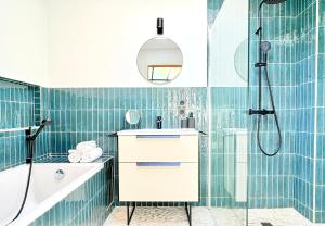 a bathroom with blue tiles and a shower at Maison nichée au coeur des vignes proche de Givry in Givry +18 photos