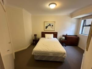 a small bedroom with a bed and a window at Regency Hyde Park, Sydney CBD, Private Bed and Bath in Sydney