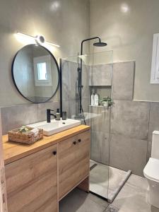 a bathroom with a sink and a shower with a mirror at 2 Doors- Luxury by the sea, easy parking in Kavála +29 photos