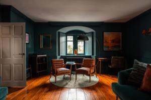 a living room with a table and chairs at Chapel House Estate in Kent