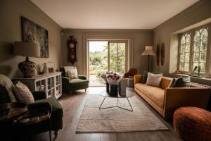 a living room with a couch and a table at Chapel House Estate in Kent