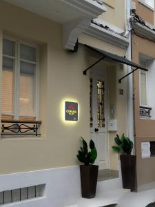 a house with two plants in front of a door at CoruñaFlat Apartamentos con encanto en el centro de A Coruña in A Coruña
