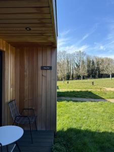 a porch with a table and chairs and a field at Chapel House Estate in Kent +16 photos