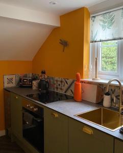 a kitchen with a sink and a stove top oven at Chapel House Estate in Kent +15 photos