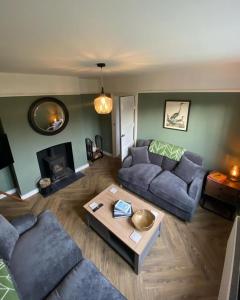 a living room with two couches and a coffee table at Chapel House Estate in Kent