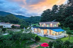 an aerial view of a house in the mountains at Peach Blossom Garden in Gangneung