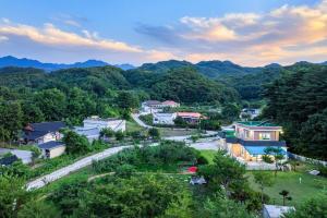 an aerial view of a village in the mountains at Peach Blossom Garden in Changdŏng-ni