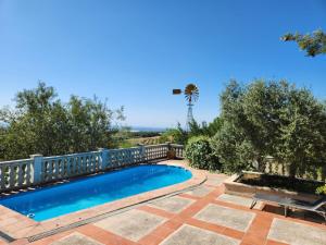 a swimming pool with a fence and a palm tree at La Muntanera - Eco Yurt - Pool, Nature retreat in Figuerola
