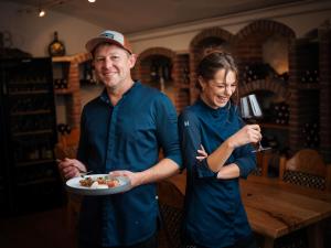 a man and a woman holding a plate of food at Landhotel Lindenhof in Feld am See