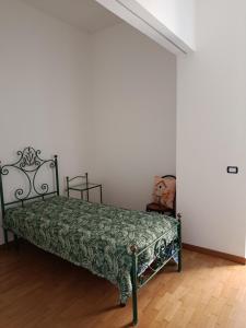 a bedroom with a green bed in a room at Salerno Eremita Apartment in Salerno +15 photos