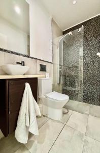 a bathroom with a toilet and a sink and a shower at Casa Miká in Parede