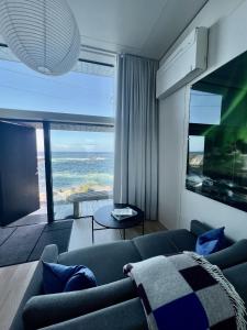 a living room with a couch and a view of the ocean at High end sea cabins at Å in Lofoten in Moskenes